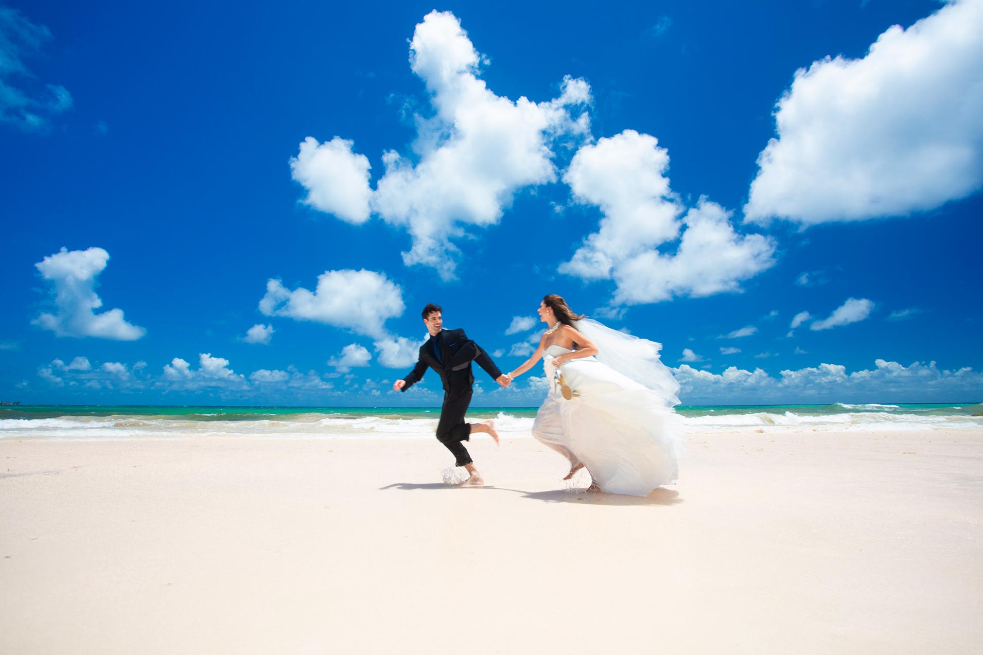 Wedding couple running on beach