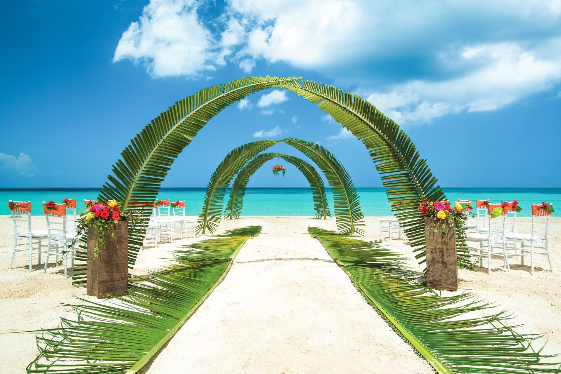 Palm leaf beach wedding setting
