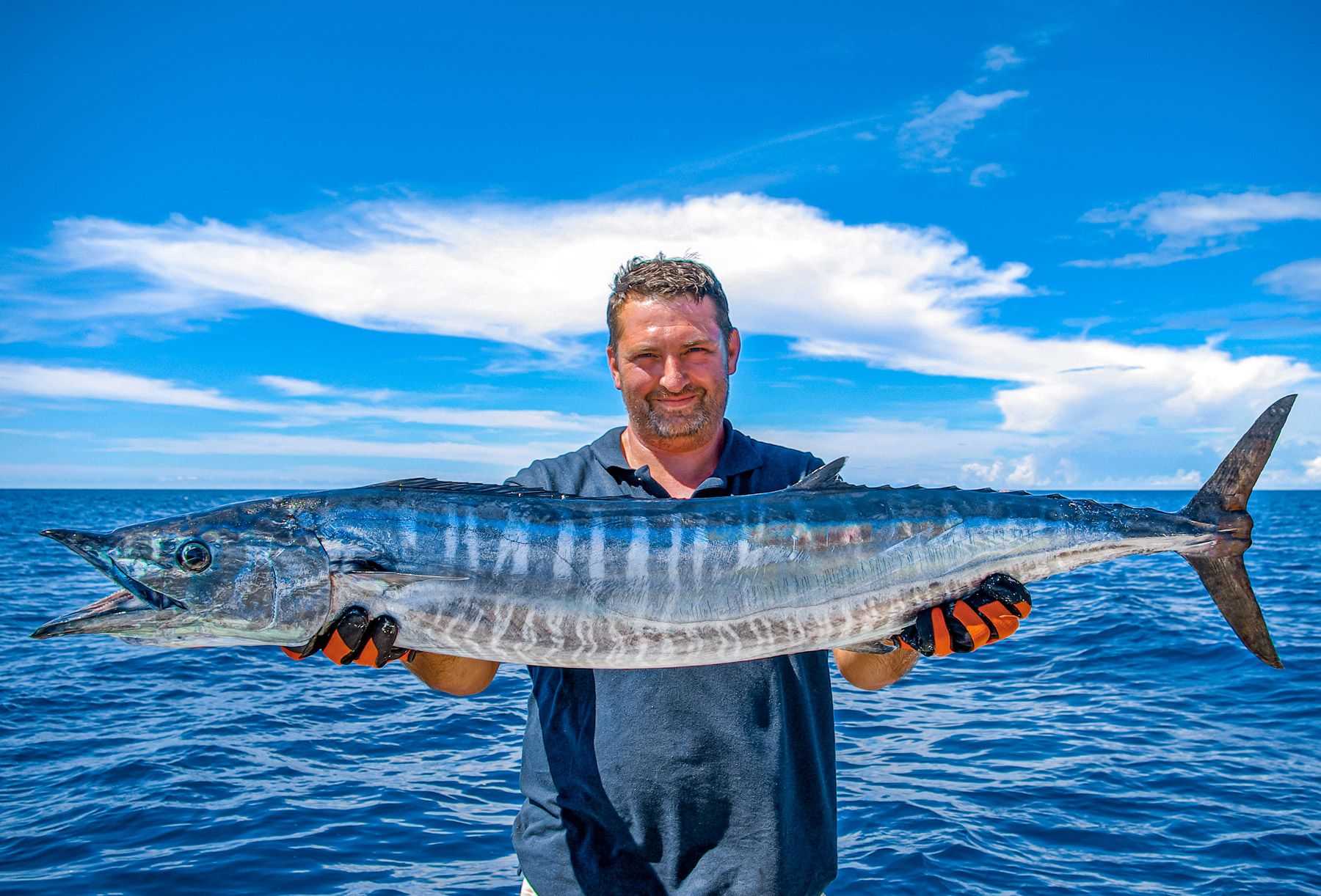 fisherman holding wahoo