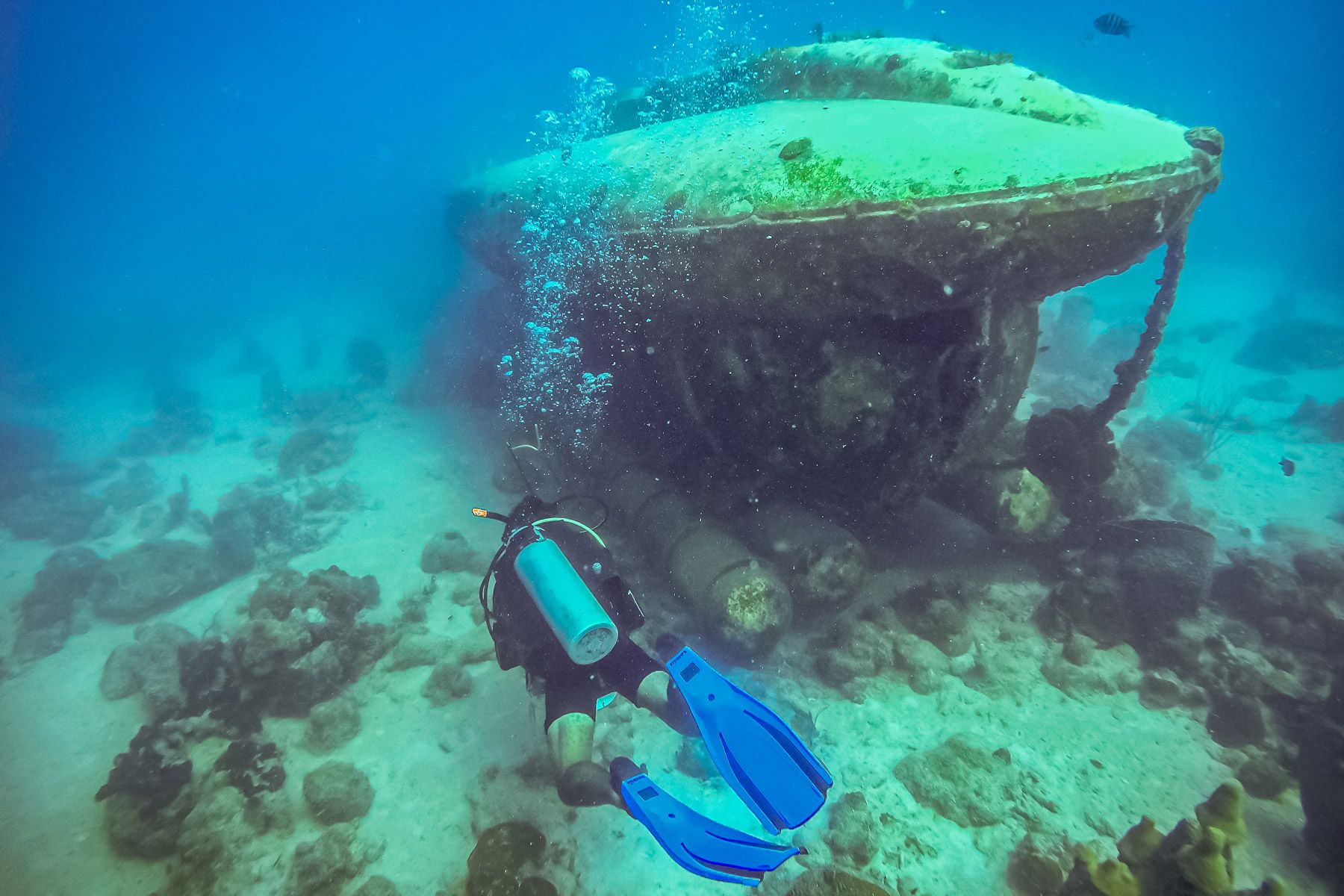 Scuba diver exploring submarine wreck