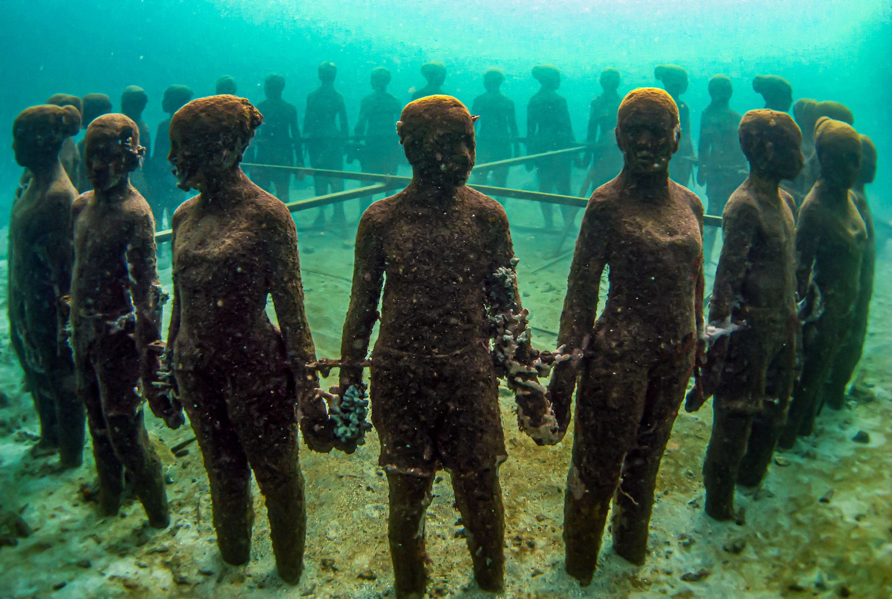 Grenada Underwater Sculpture Park children holding hands in a circle