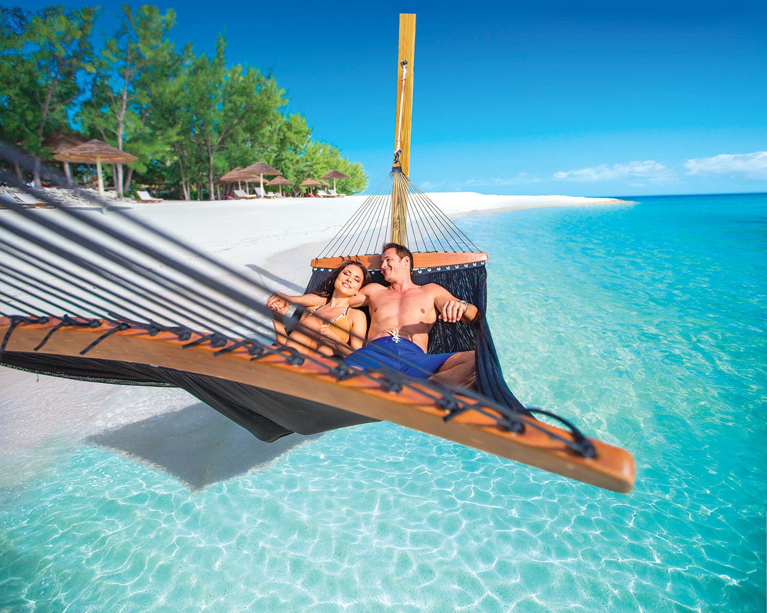 couple in overwater hammock
