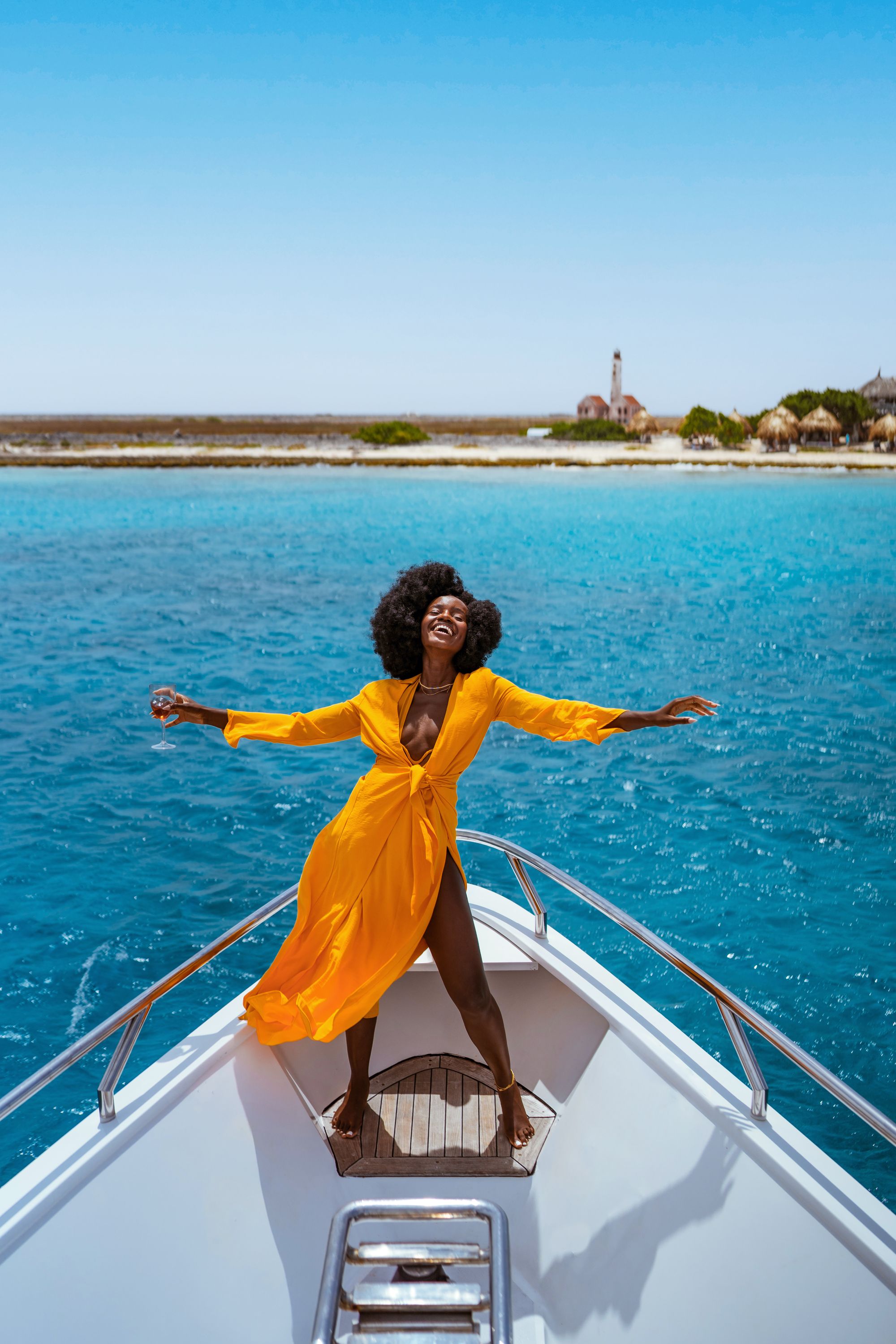 woman-in-yellow-dress-on-boat-in-the-ocean
