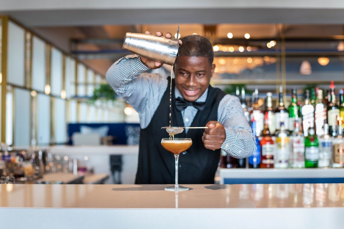 bartender at sandals royal bahamian making a cocktail
