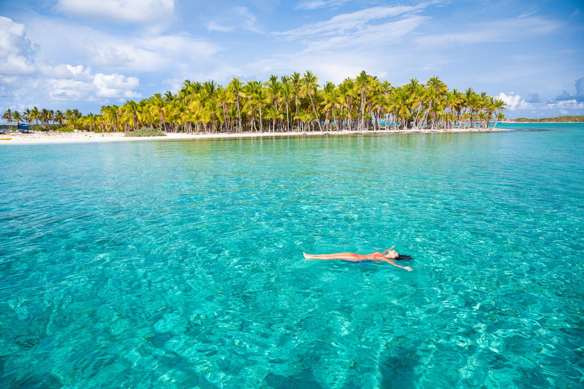 woman floating near coconut island bahamas