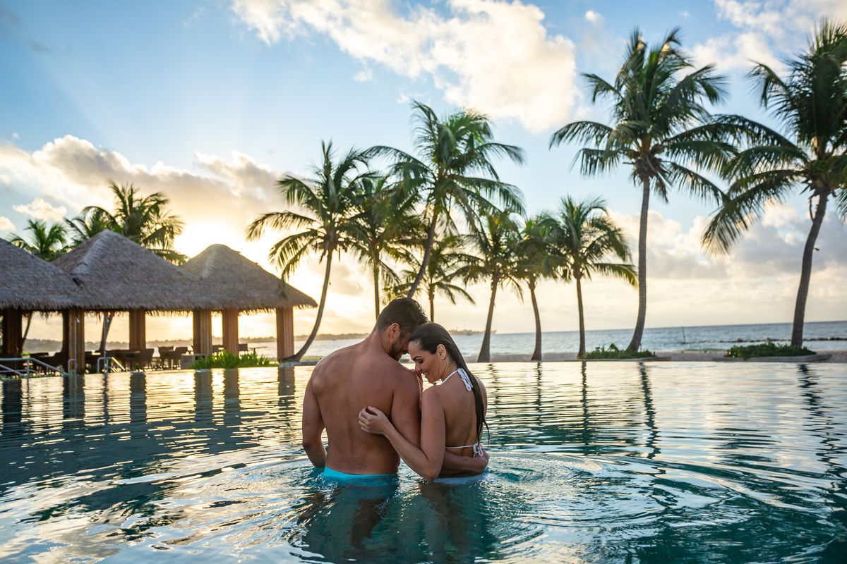 couple in pool at sunset sandals royal barbados