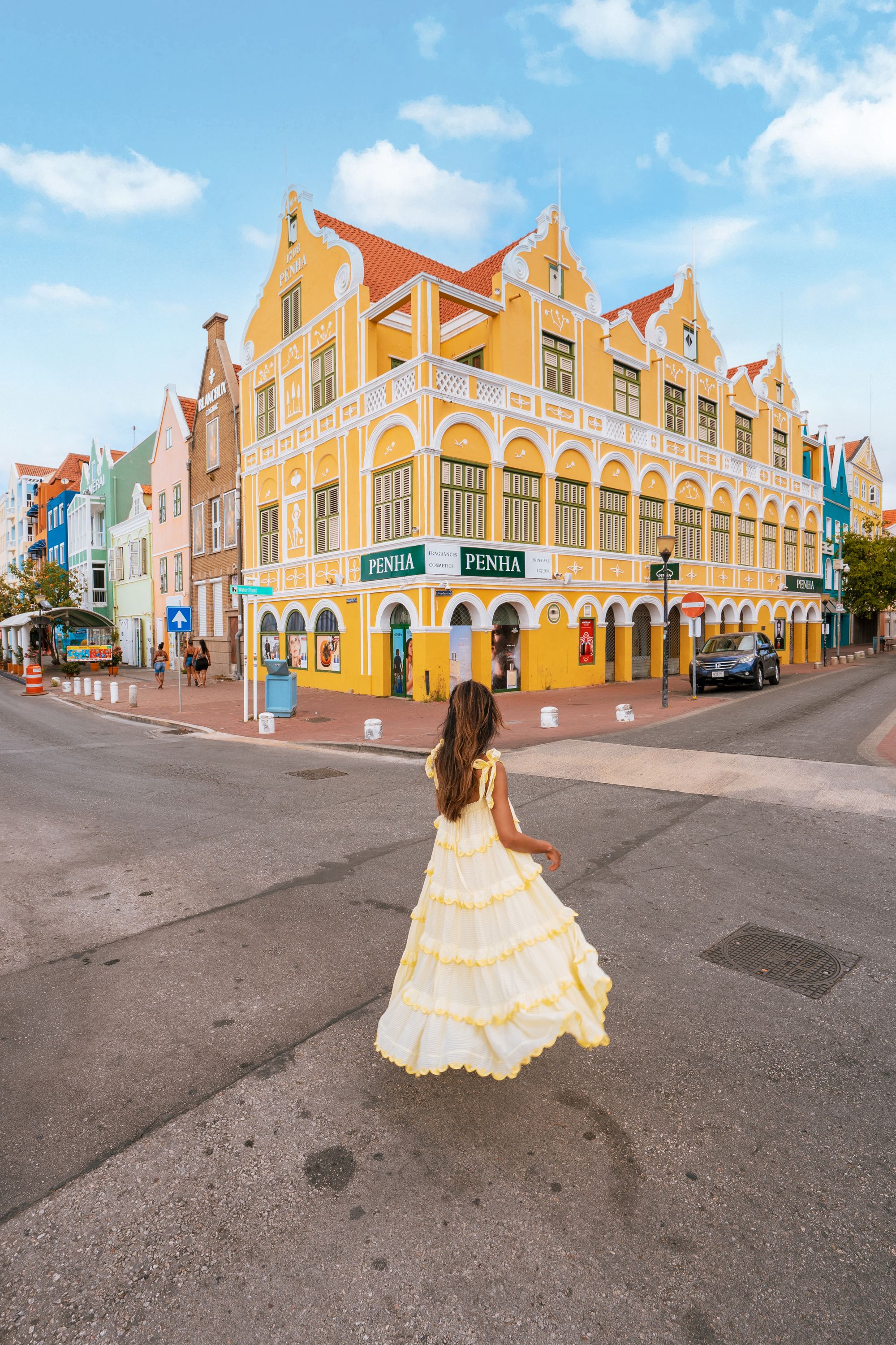 woman in yellow dress exploring willemstad curacao
