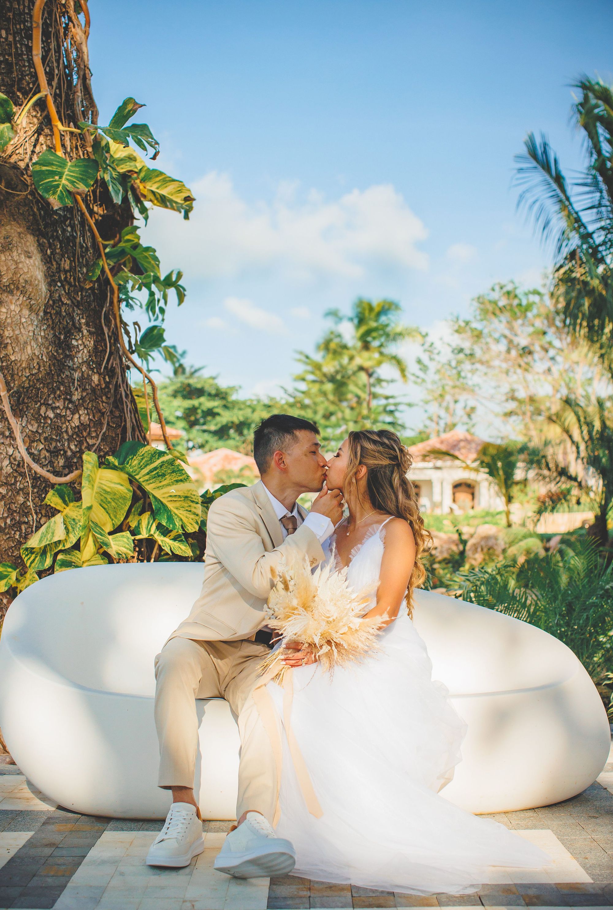 couple in wedding attire kissing in Jamaica