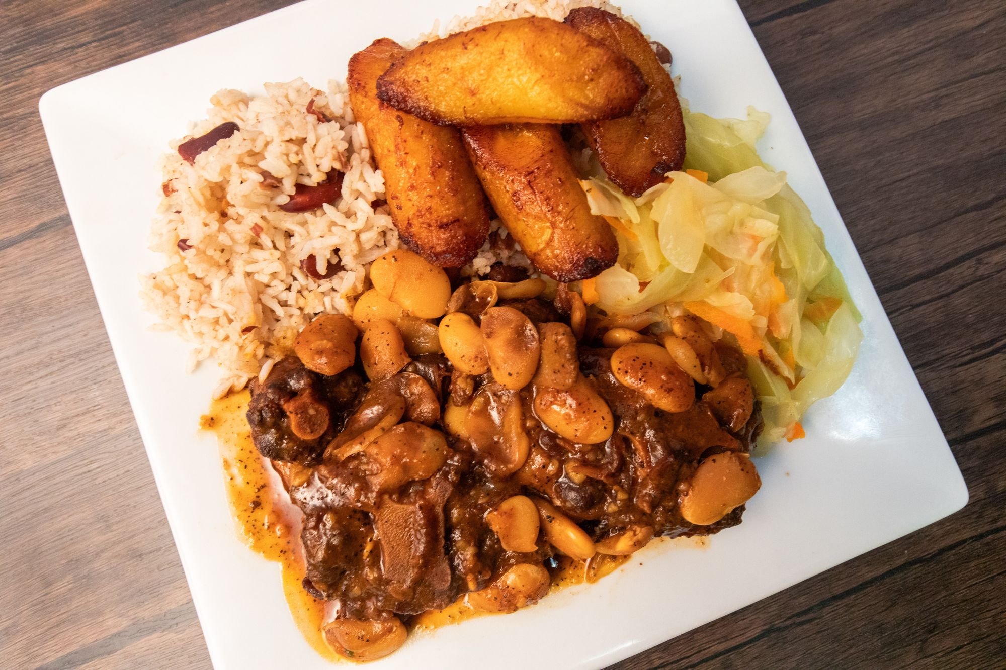 jamaican oxtails with plantain, cabbage, and rice and peas