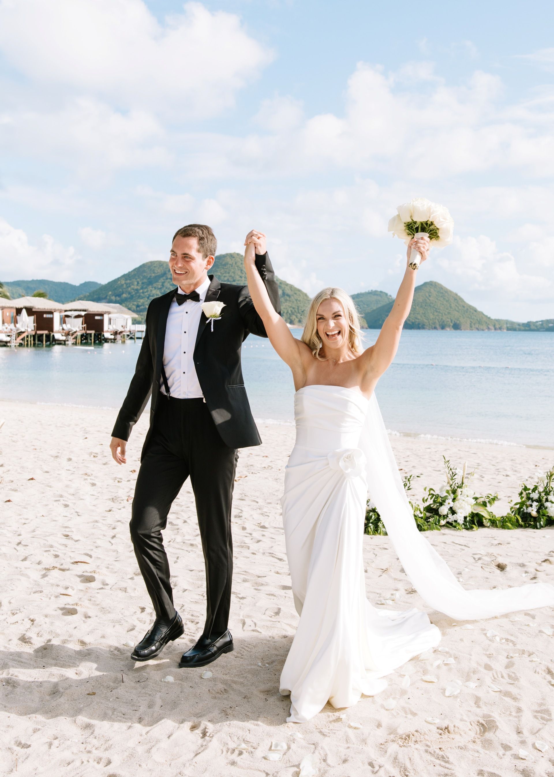 just-married couple celebrating on the beach in St. Lucia