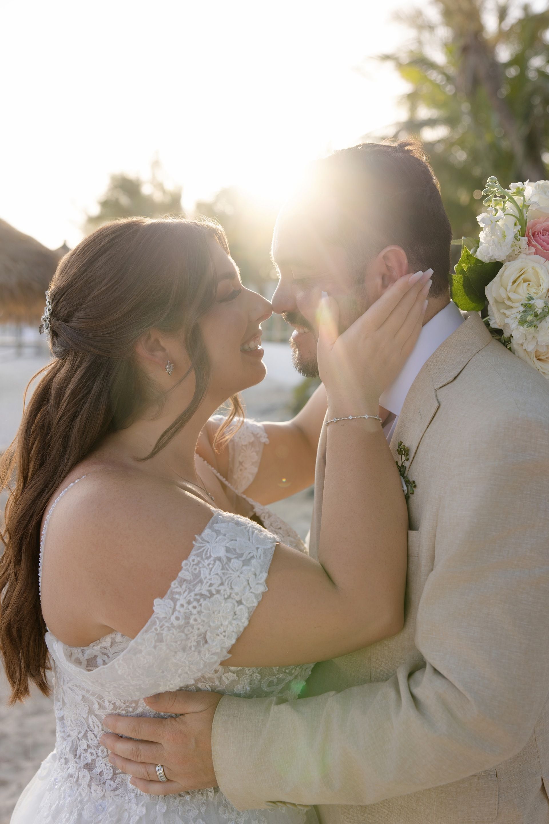 Close-up of bride and groom laughing in golden sunlight at Sandals wedding