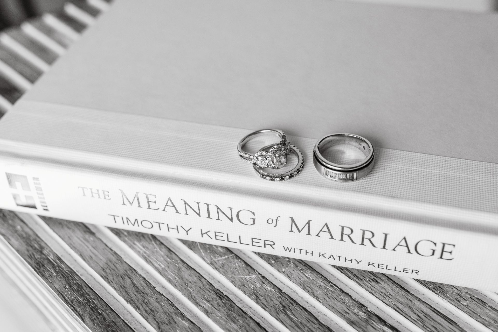Wedding rings resting on a book about the meaning of marriage