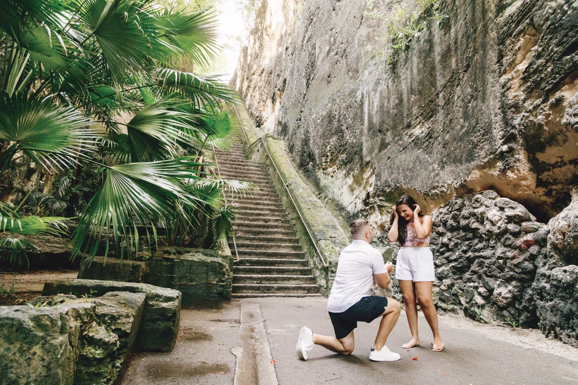 Man proposing to partner in lush tropical setting during Caribbean vacation