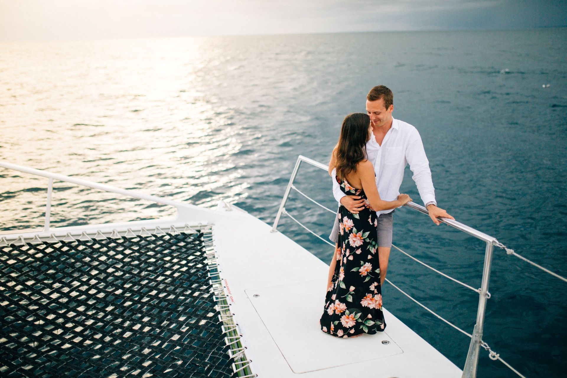 Couple celebrating romantic moment on catamaran sailing in the Caribbean
