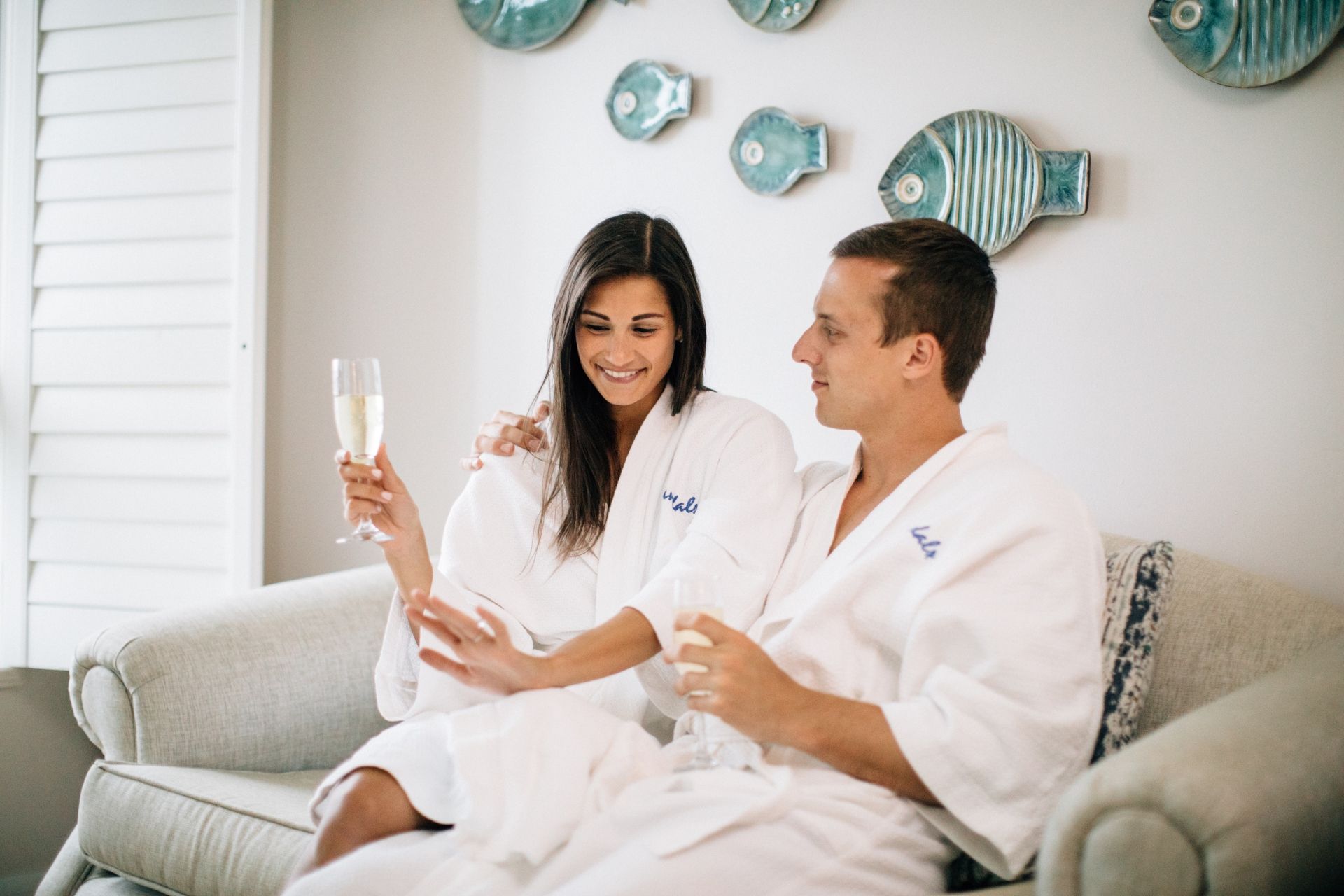 Couple celebrating romantic moment with champagne in luxury Sandals suite