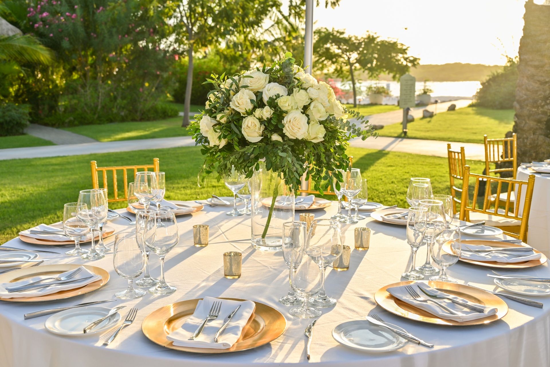 Elegant dining table with floral centerpiece at Caribbean vow renewal reception