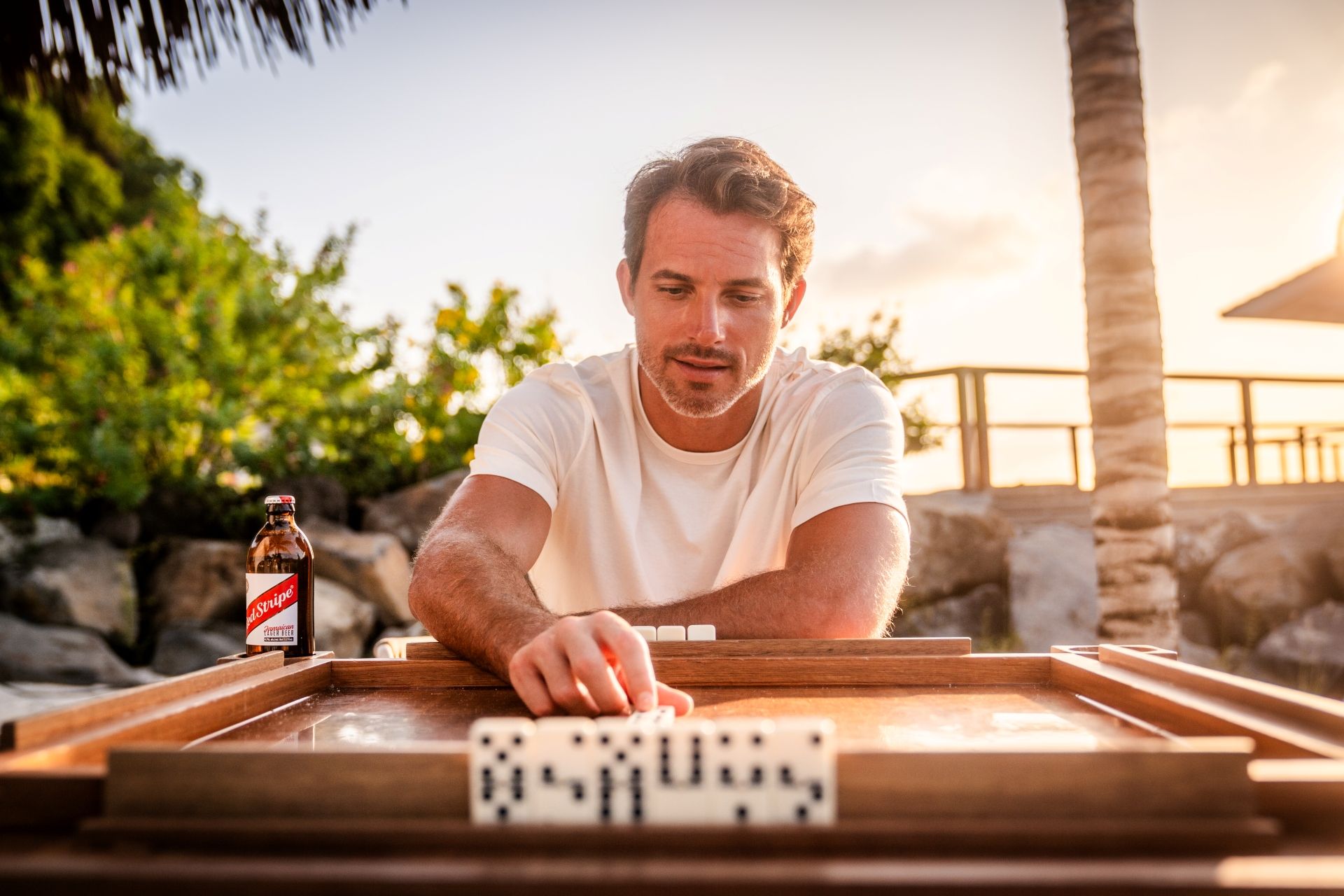 man playing dominoes outdoor caribbean wedding interactive entertainment