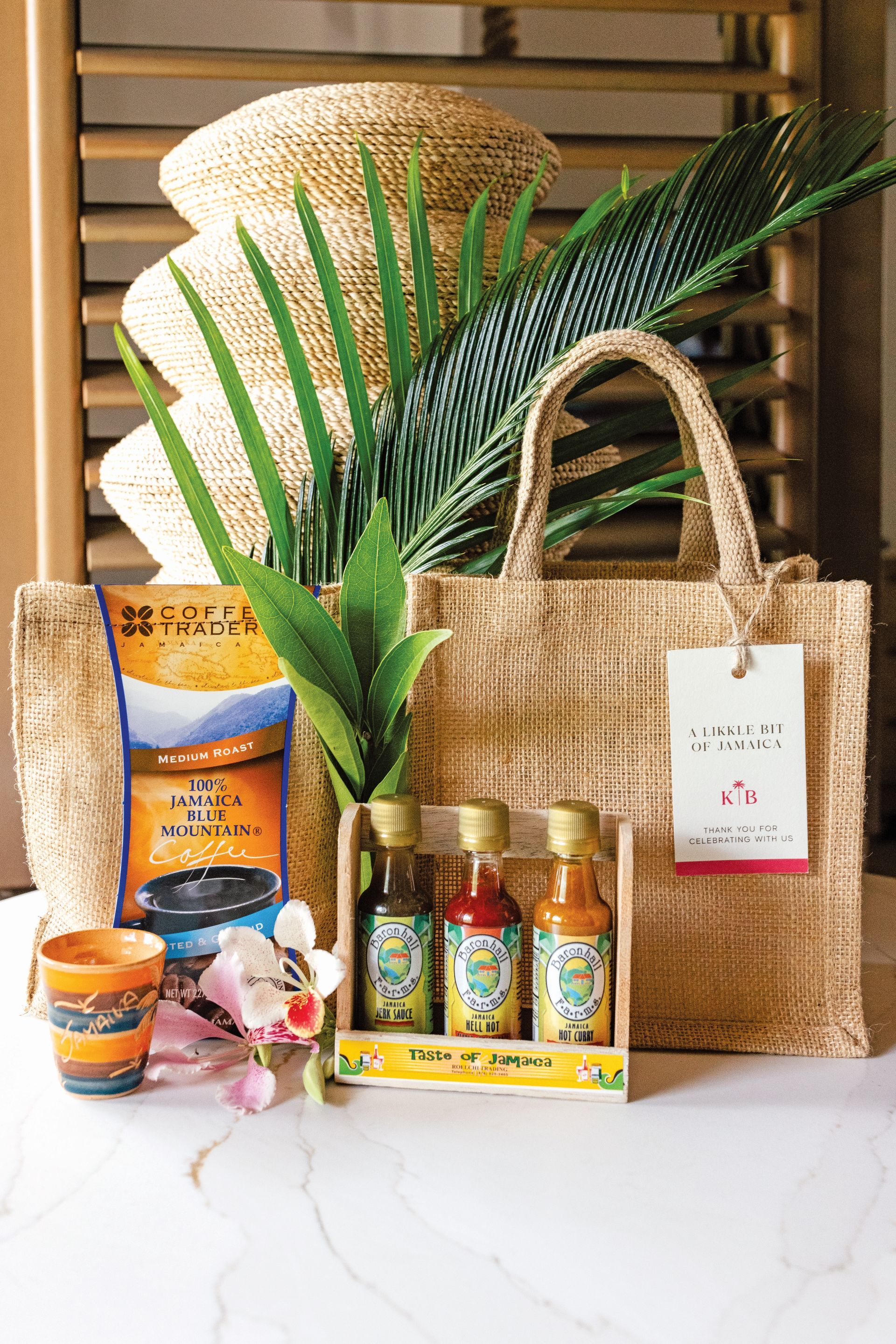 Jamaica-themed wedding welcome gift bag with Blue Mountain coffee, local hot sauces, and Jamaican souvenirs at Sandals Dunn's River, Ocho Rios