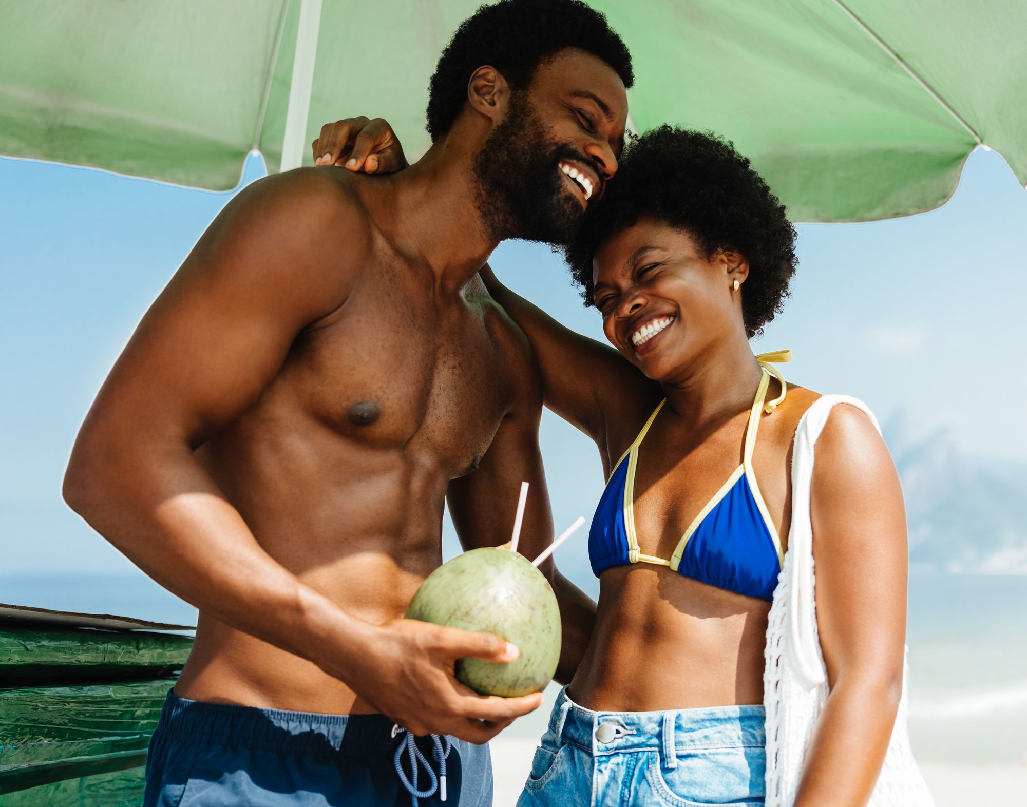 couple-laughing-sipping-coconut-island-saint-lucia